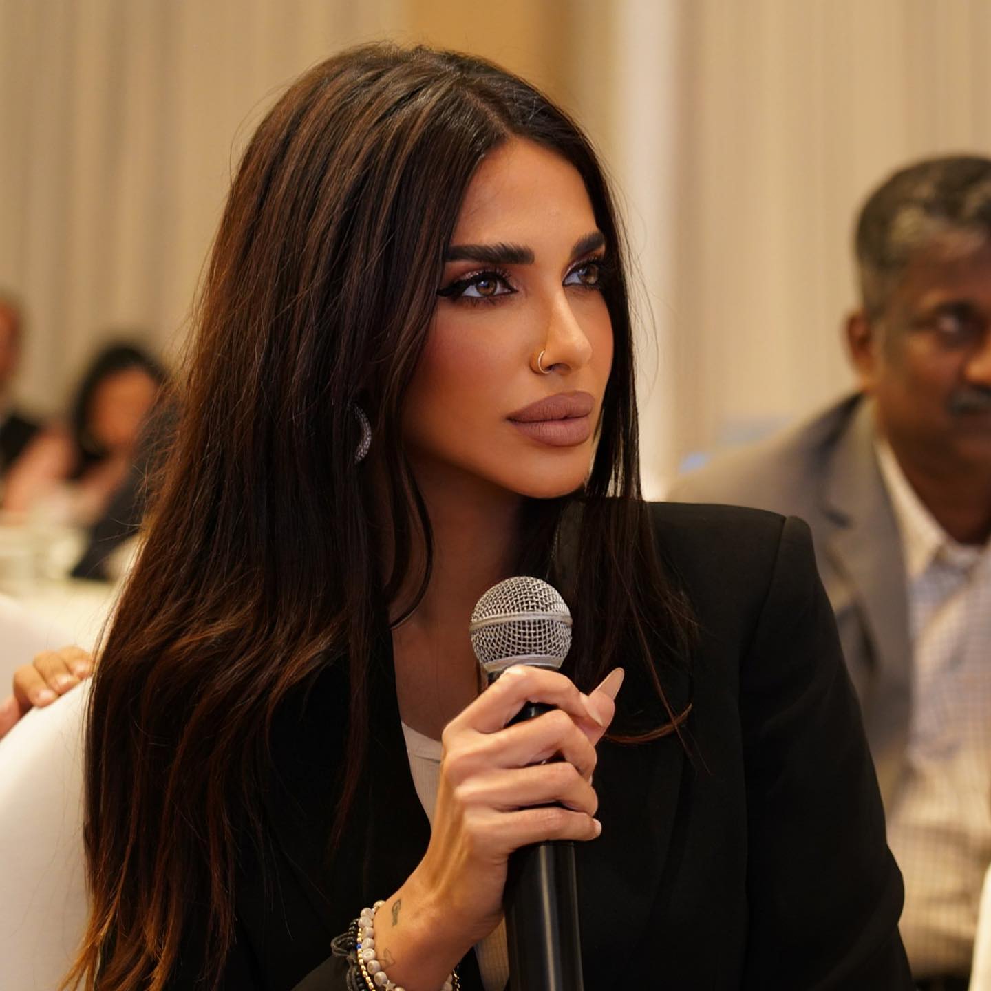 Sara Al Madani speaking into a microphone