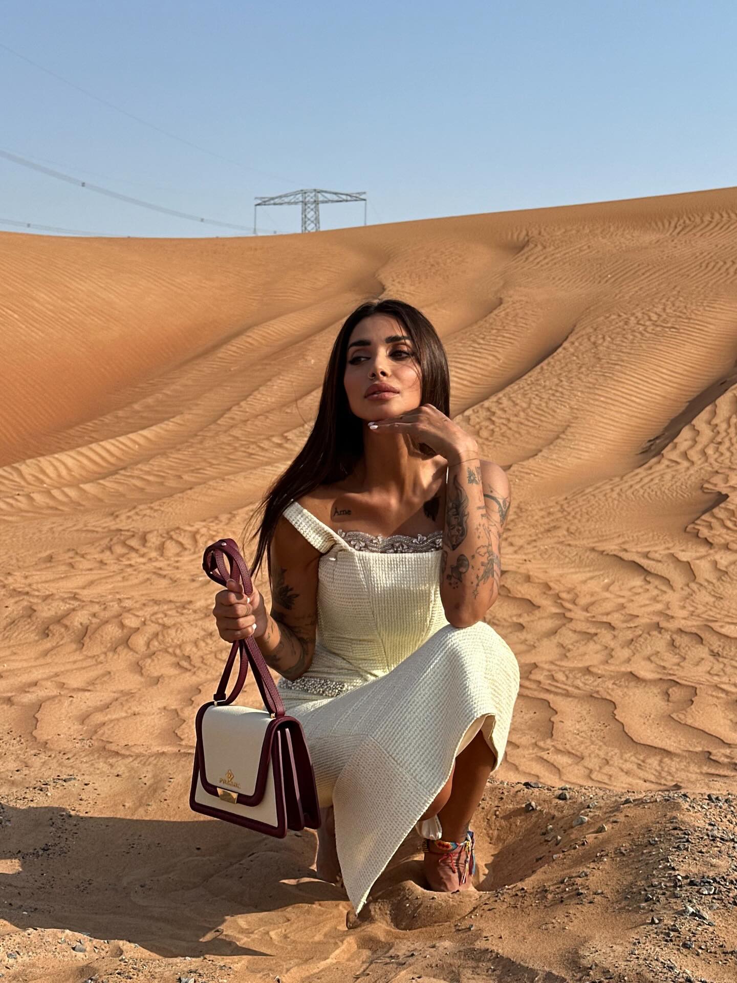 Sara Al Madani in white in the desert
