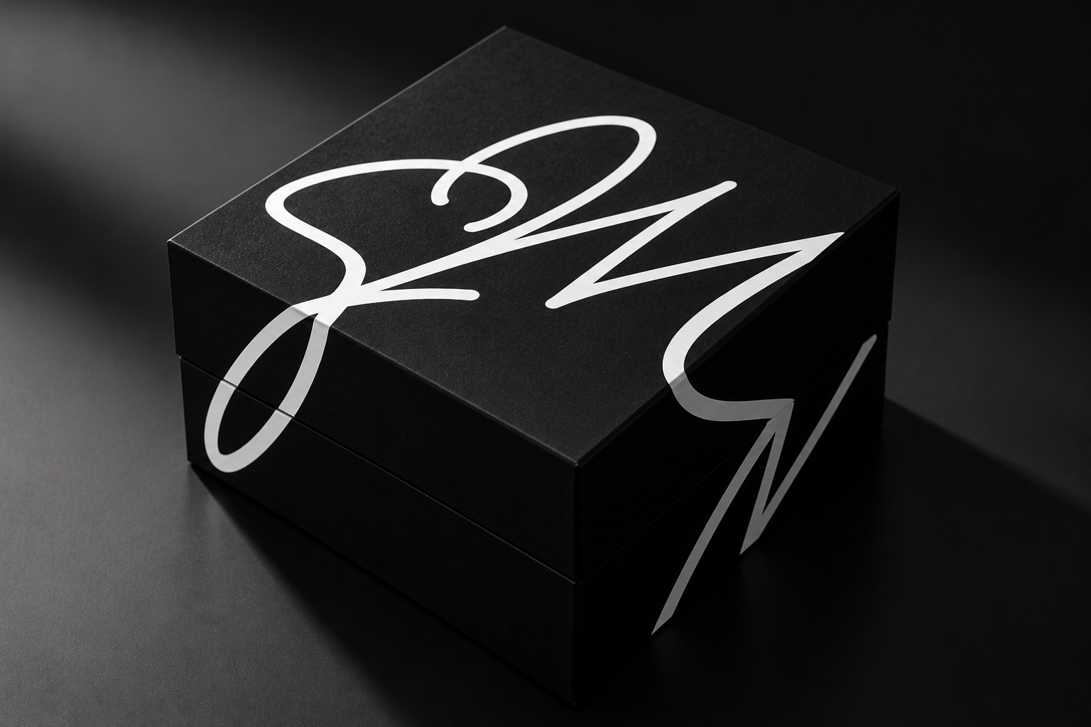 Black collector box with white Sara Al Madani calligraphy