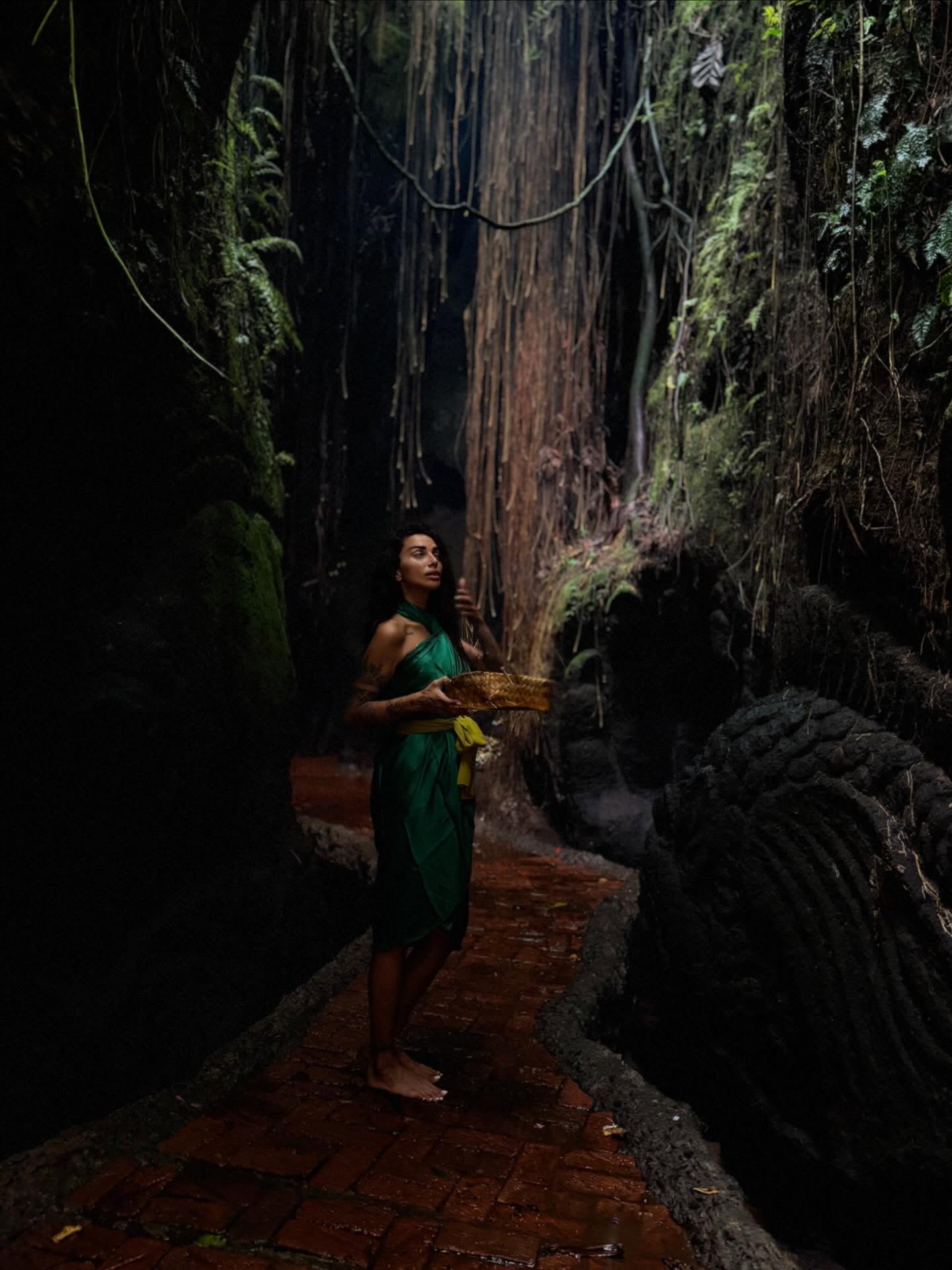 Sara Al Madani on a forest waterfall path