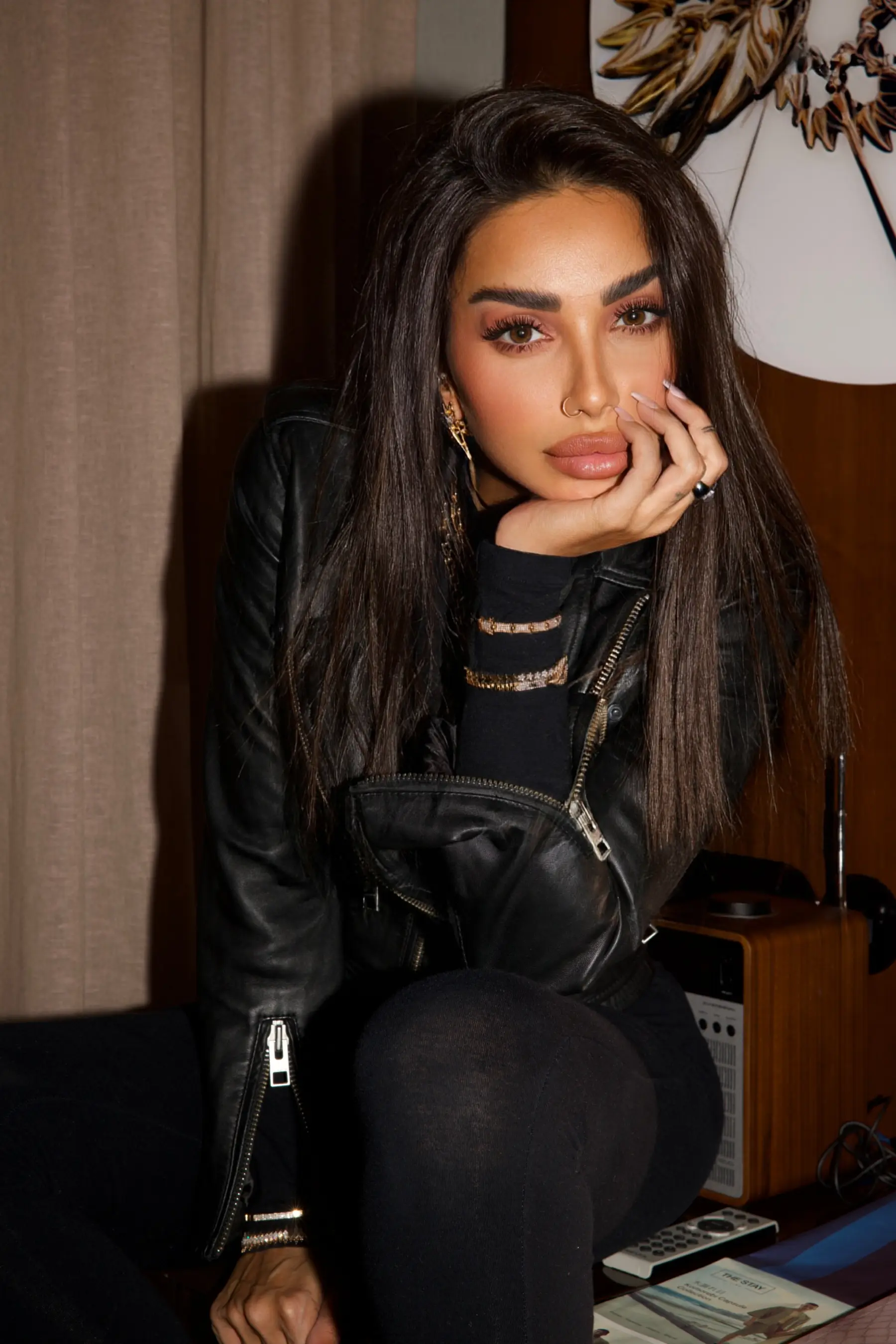 Sara Al Madani in black against a dark background