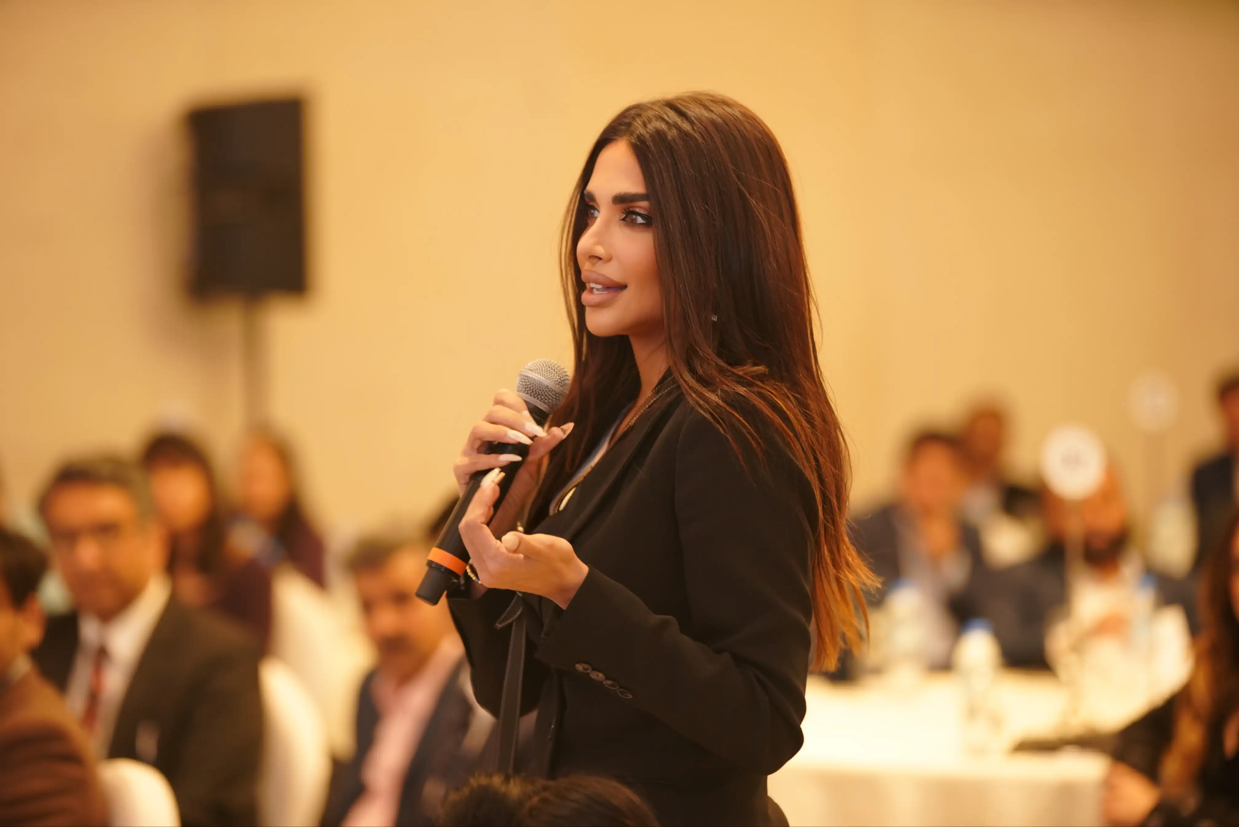Sara Al Madani speaking into a microphone