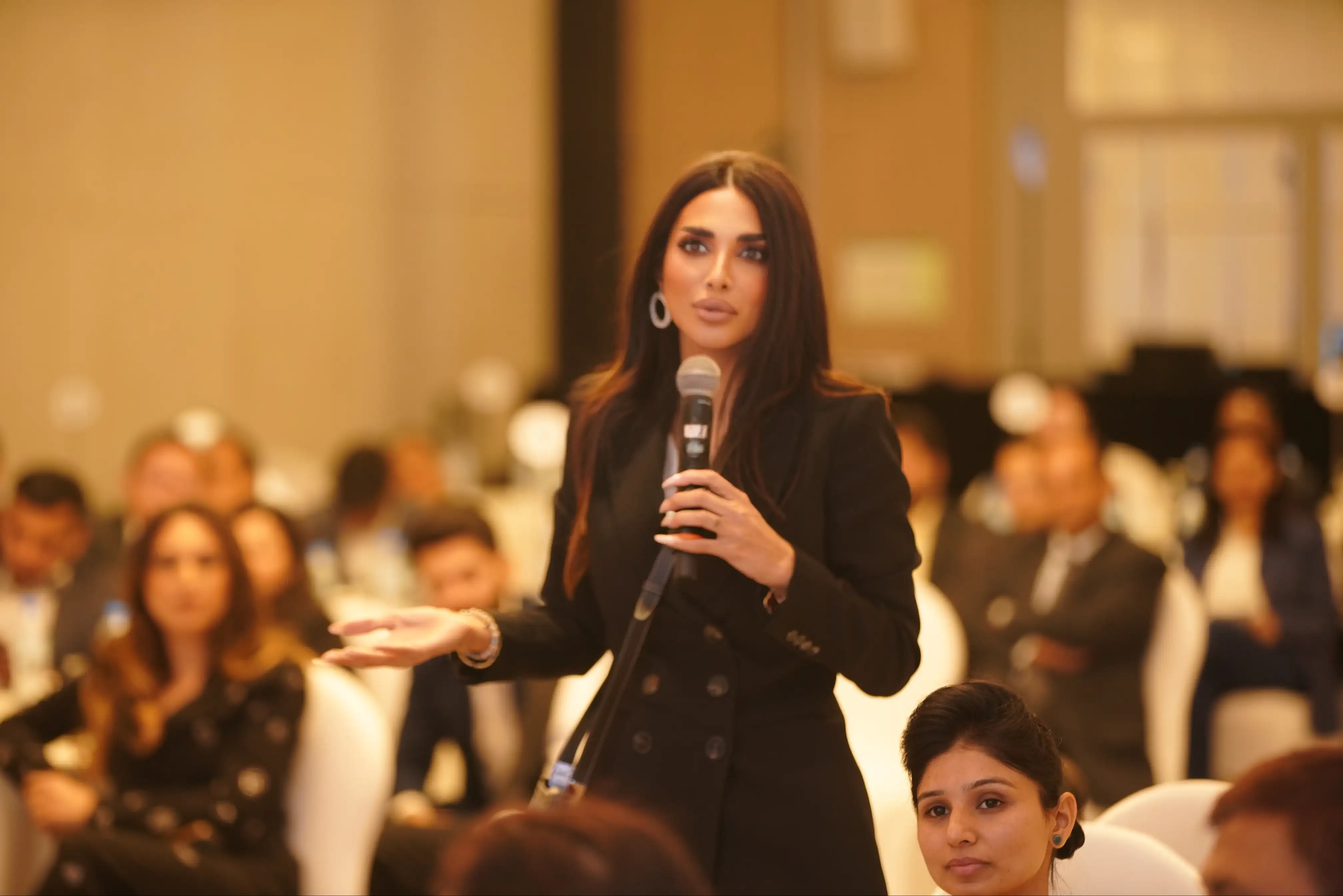 Sara Al Madani speaking to an audience